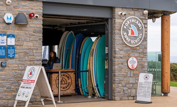 Image of a member of staff at the reception and welcome centre of the surf school.